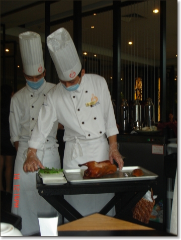 chef prepares peking duck